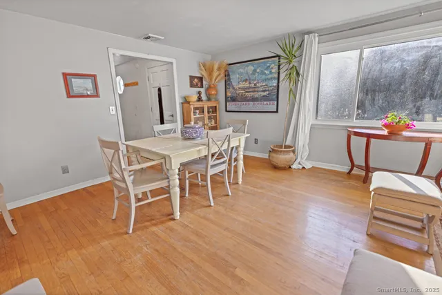 a living room with furniture fireplace and a large window