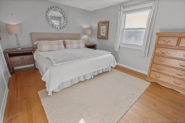 a bedroom with a bed and a mirror