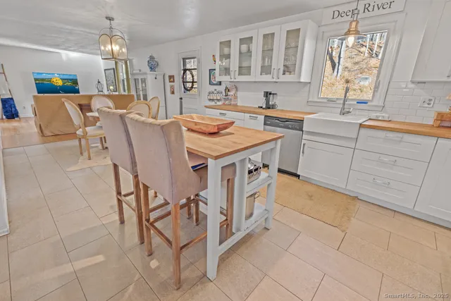 a kitchen with a table chairs refrigerator and cabinets