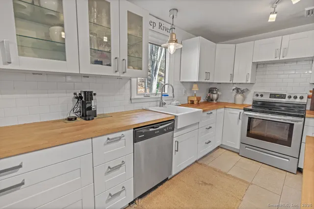 a view of a dining room with furniture and a chandelier