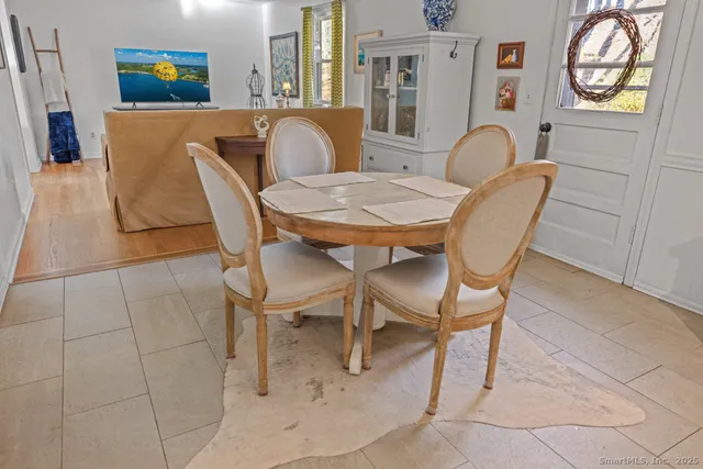 a kitchen with stainless steel appliances a table chairs and a refrigerator