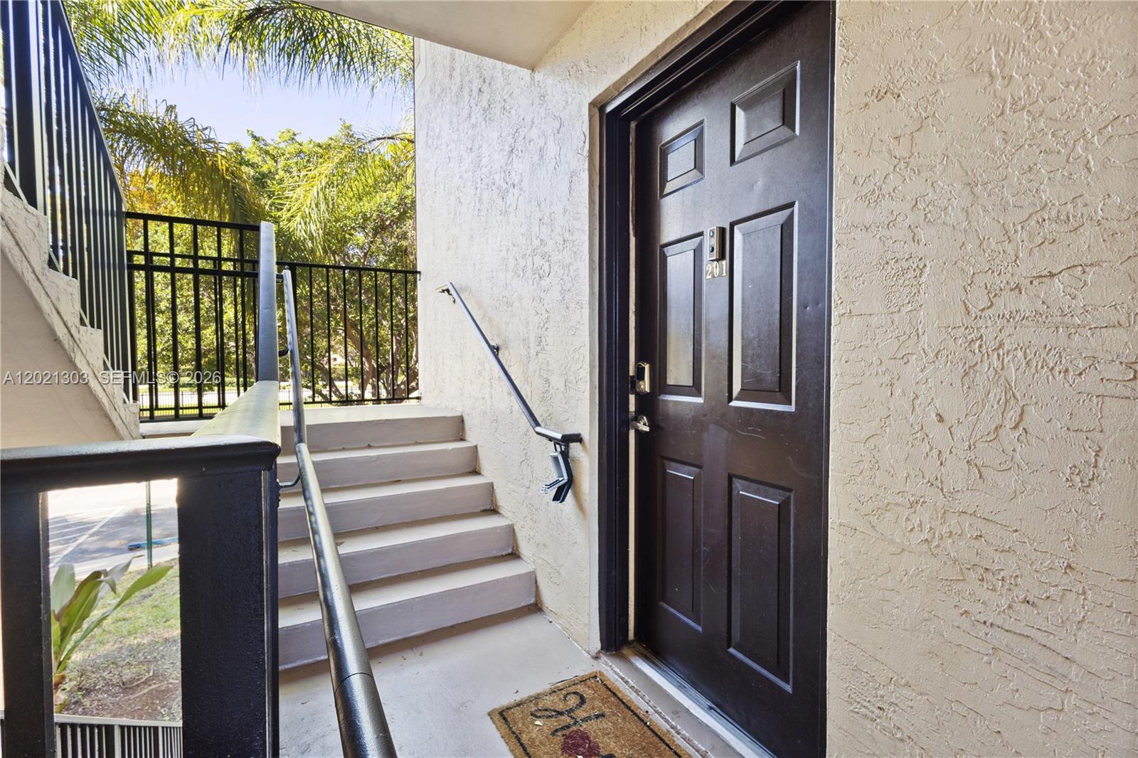 2123 Renaissance Boulevard, Unit 201 Miramar, FL 33025 - Photo 5 of 22 a view of entryway with wooden floor and a front door