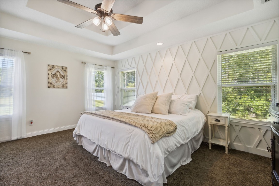 37221 Poole Road Hilliard, FL 32046 - Photo 11 of 67 a spacious bedroom with a bed and a window