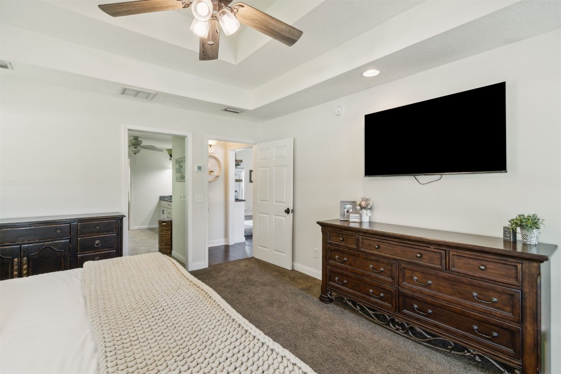 37221 Poole Road Hilliard, FL 32046 - Photo 12 of 67 a bedroom with a bed and a flat screen tv