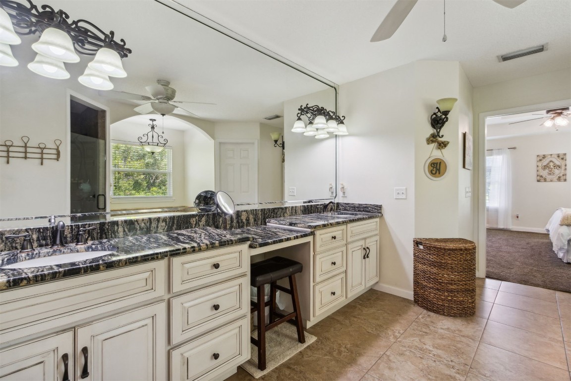 37221 Poole Road Hilliard, FL 32046 - Photo 13 of 67 a spacious bathroom with a granite countertop double vanity sink mirror bathtub and shower