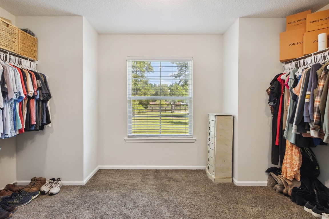 37221 Poole Road Hilliard, FL 32046 - Photo 15 of 67 a view of walk in closet with clothes and shoes
