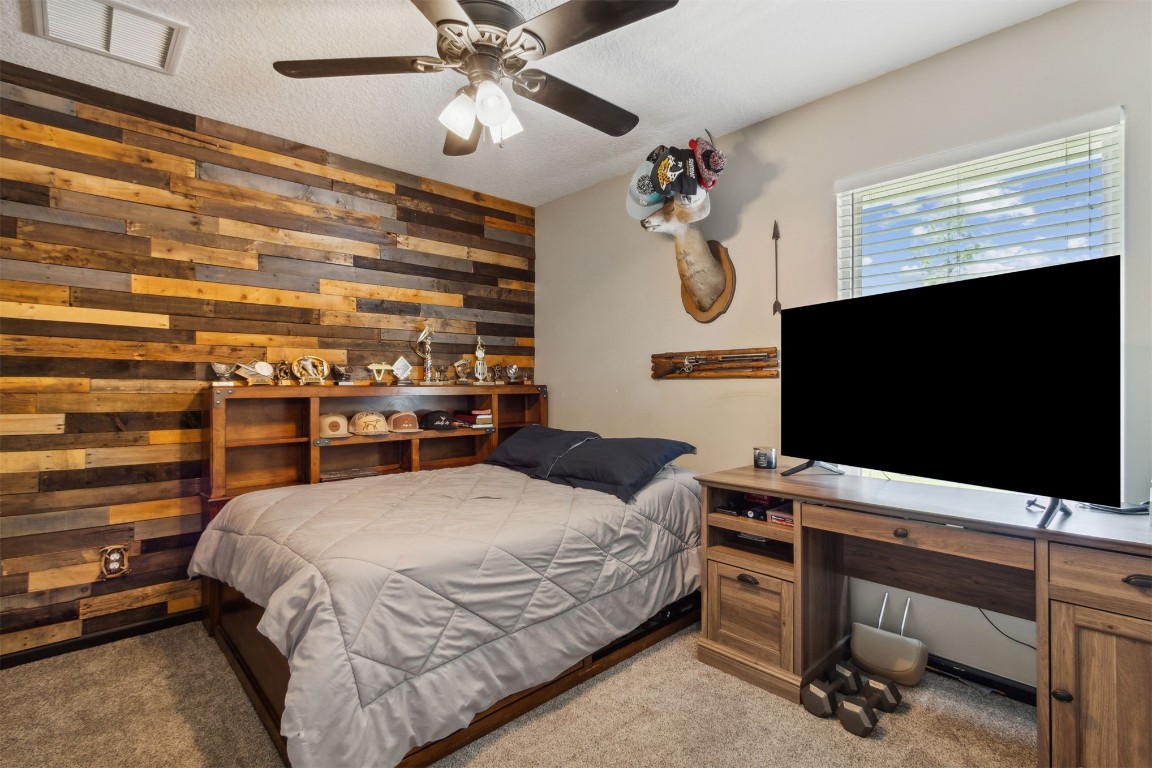 37221 Poole Road Hilliard, FL 32046 - Photo 16 of 67 a bedroom with a bed and a flat screen tv