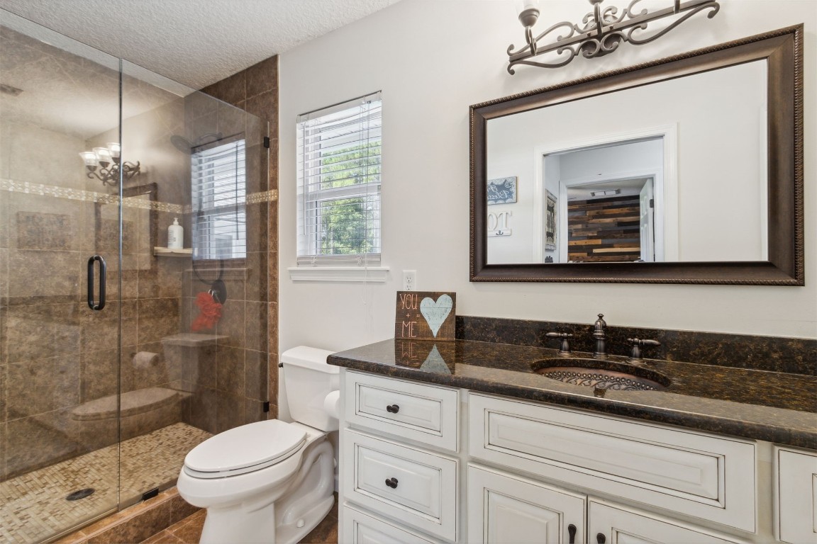 37221 Poole Road Hilliard, FL 32046 - Photo 18 of 67 a bathroom with a sink a toilet and shower