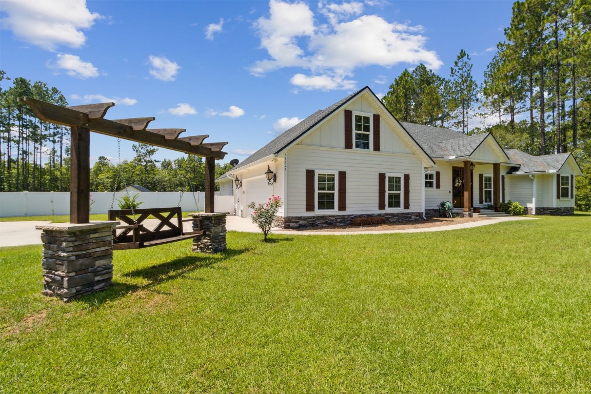 37221 Poole Road Hilliard, FL 32046 - Photo 2 of 67 a front view of a house with garden