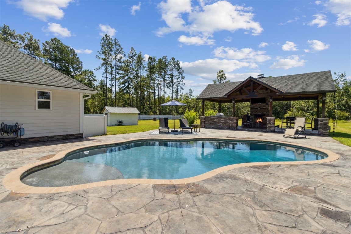 37221 Poole Road Hilliard, FL 32046 - Photo 23 of 67 a view of a swimming pool with a lounge chairs