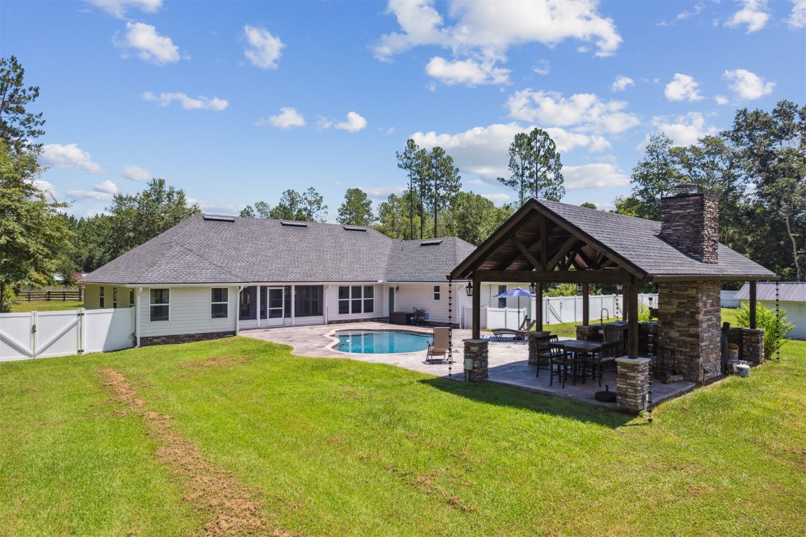 37221 Poole Road Hilliard, FL 32046 - Photo 25 of 67 a view of a house with a big yard and potted plants