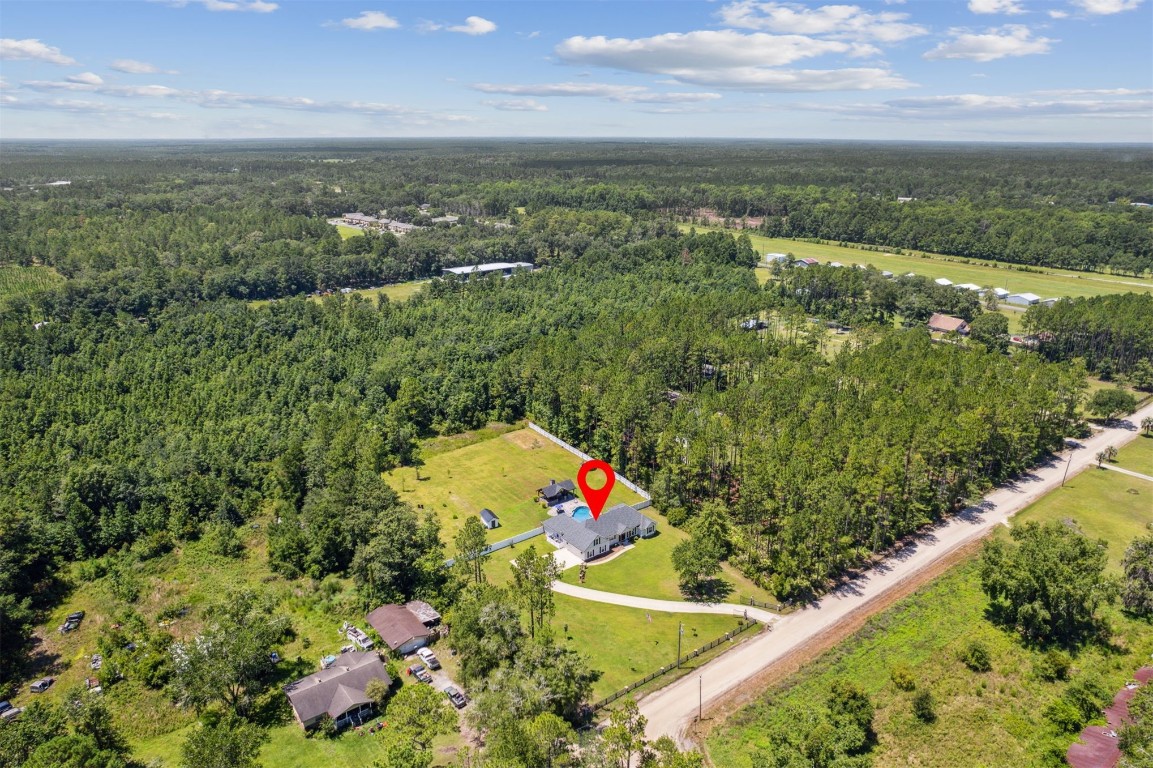 37221 Poole Road Hilliard, FL 32046 - Photo 38 of 67 an aerial view of residential houses with outdoor space and trees