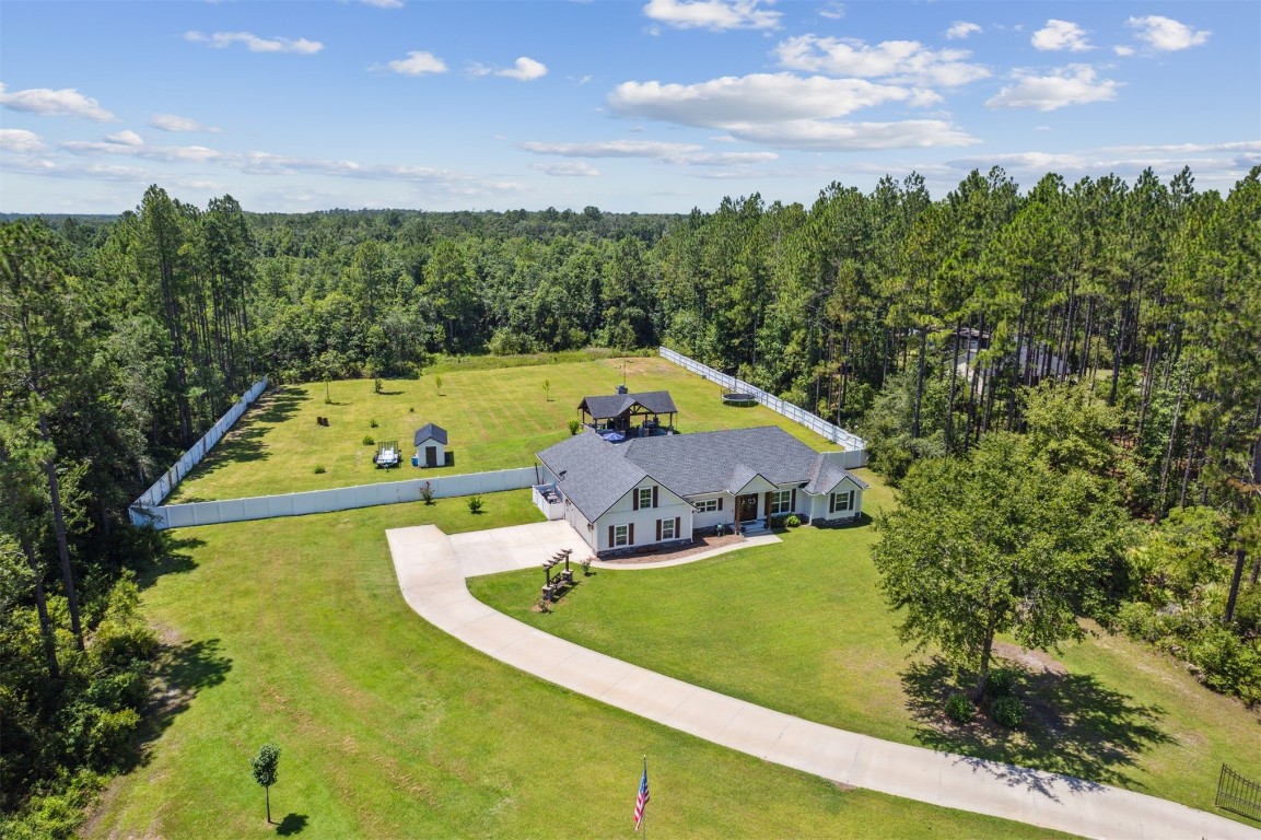 37221 Poole Road Hilliard, FL 32046 - Photo 40 of 67 a view of a swimming pool with a yard