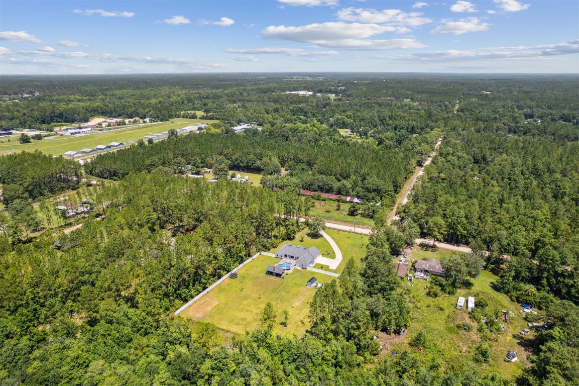 37221 Poole Road Hilliard, FL 32046 - Photo 44 of 67 an aerial view of residential houses with outdoor space and trees