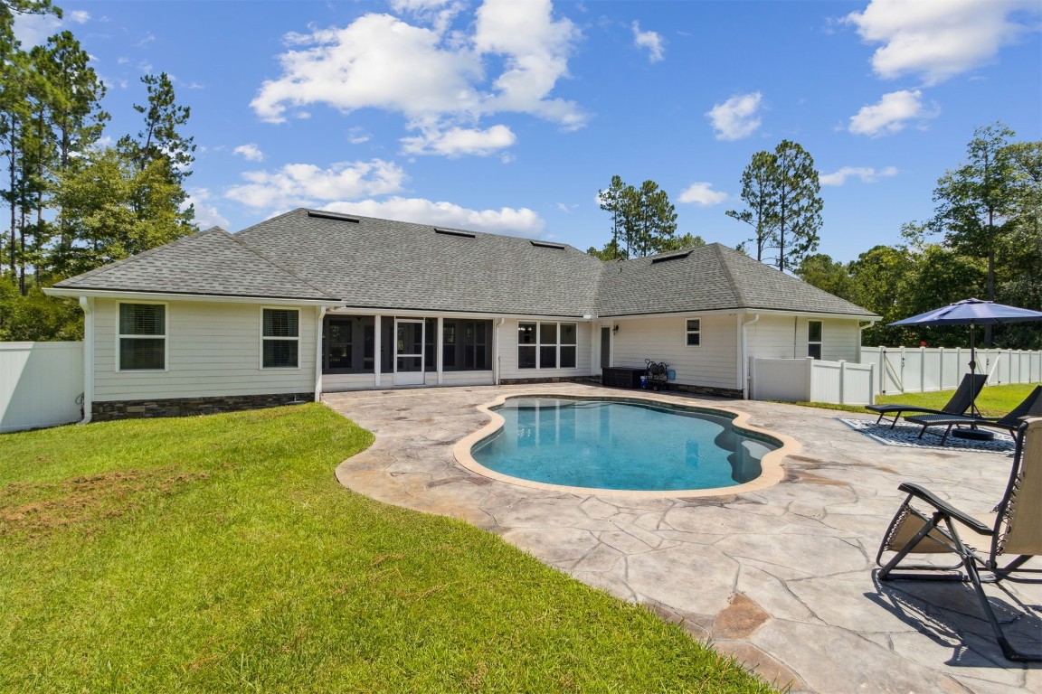 37221 Poole Road Hilliard, FL 32046 - Photo 46 of 67 a view of a house with backyard swimming pool and sitting area