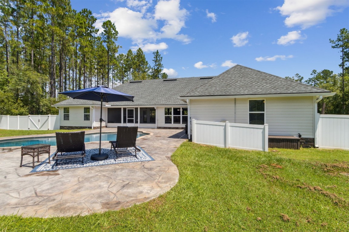 37221 Poole Road Hilliard, FL 32046 - Photo 58 of 67 a front view of a house with a yard outdoor seating and barbeque oven