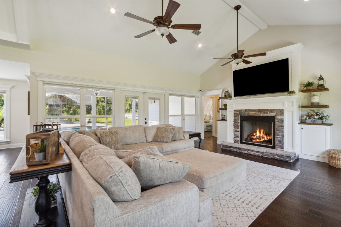 37221 Poole Road Hilliard, FL 32046 - Photo 59 of 67 a living room with furniture a flat screen tv and a fireplace