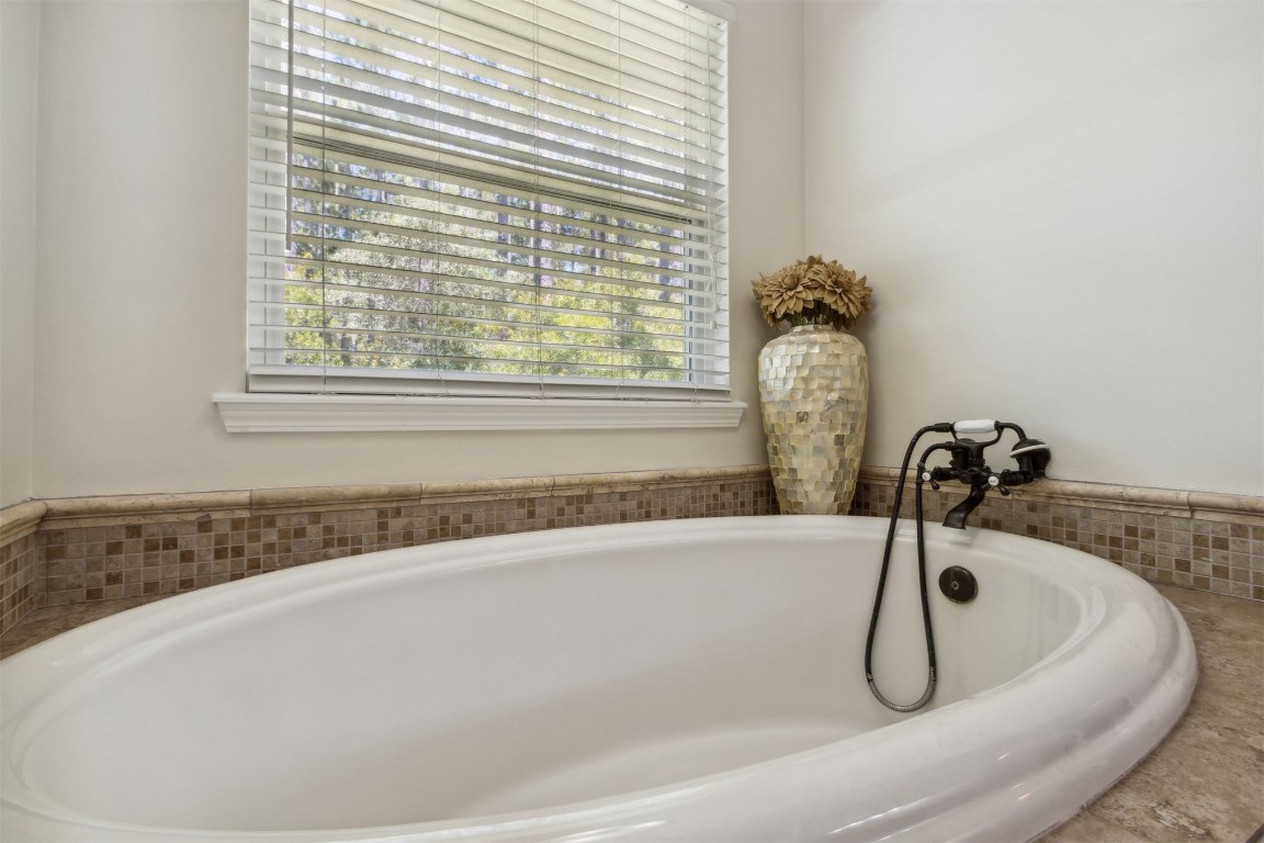37221 Poole Road Hilliard, FL 32046 - Photo 61 of 67 a bath tub sitting in a bathroom next to a window