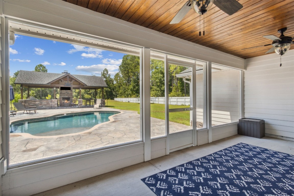37221 Poole Road Hilliard, FL 32046 - Photo 63 of 67 a view of a living room and a floor to ceiling window