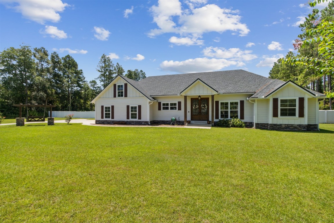 37221 Poole Road Hilliard, FL 32046 - Photo 64 of 67 a front view of a house with a garden