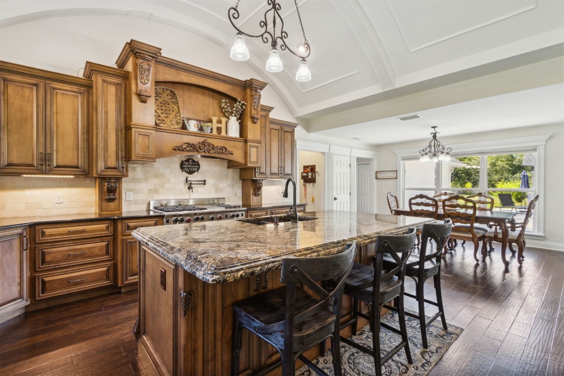 37221 Poole Road Hilliard, FL 32046 - Photo 8 of 67 a kitchen with stainless steel appliances granite countertop table chairs stove and cabinets
