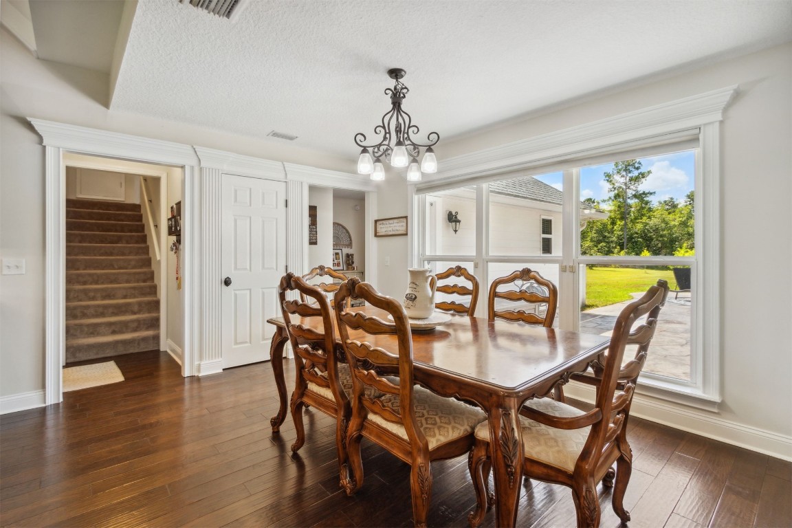 37221 Poole Road Hilliard, FL 32046 - Photo 9 of 67 a view of a dining room with furniture and wooden floor