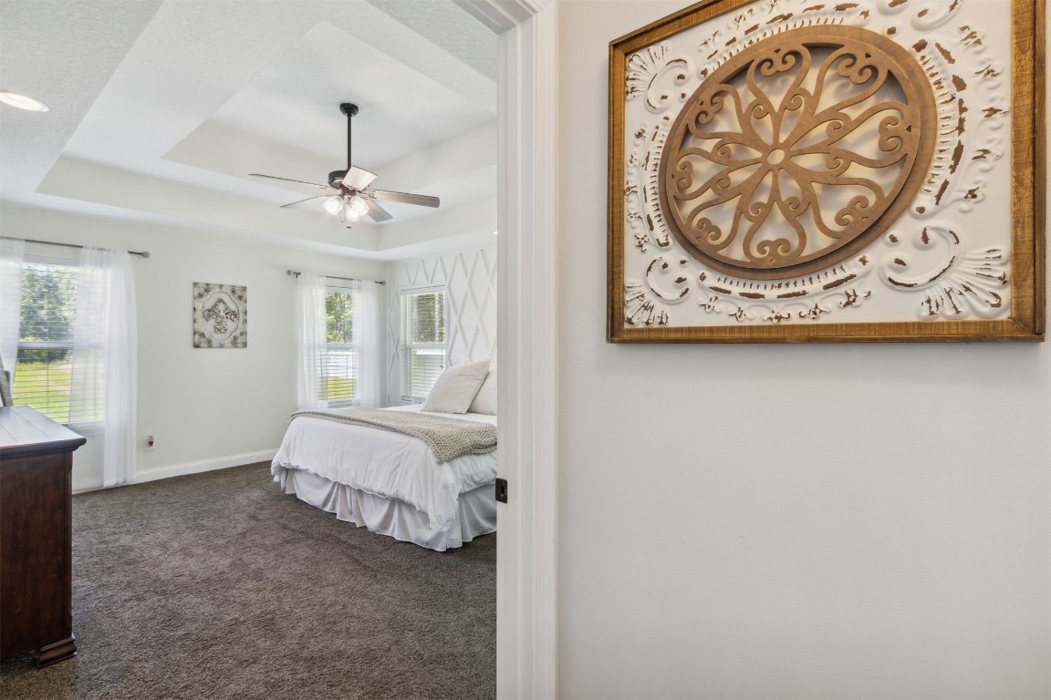 37221 Poole Road Hilliard, FL 32046 - Photo 10 of 67 a spacious bedroom with a bed and painting on the wall