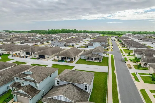 a view of a house with backyard porch and sitting area