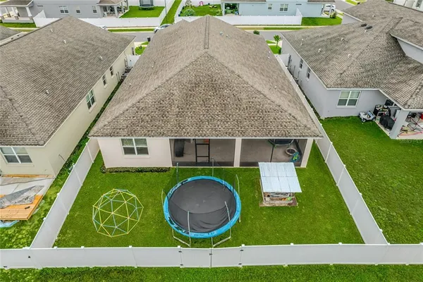 a kitchen with a dining table chairs refrigerator and cabinets
