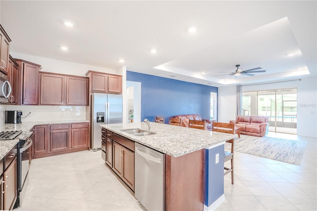 6200 Southwest 72nd Terrace Ocala, FL 34474 - Photo 25 of 70 a kitchen with a stove a sink a refrigerator and chairs