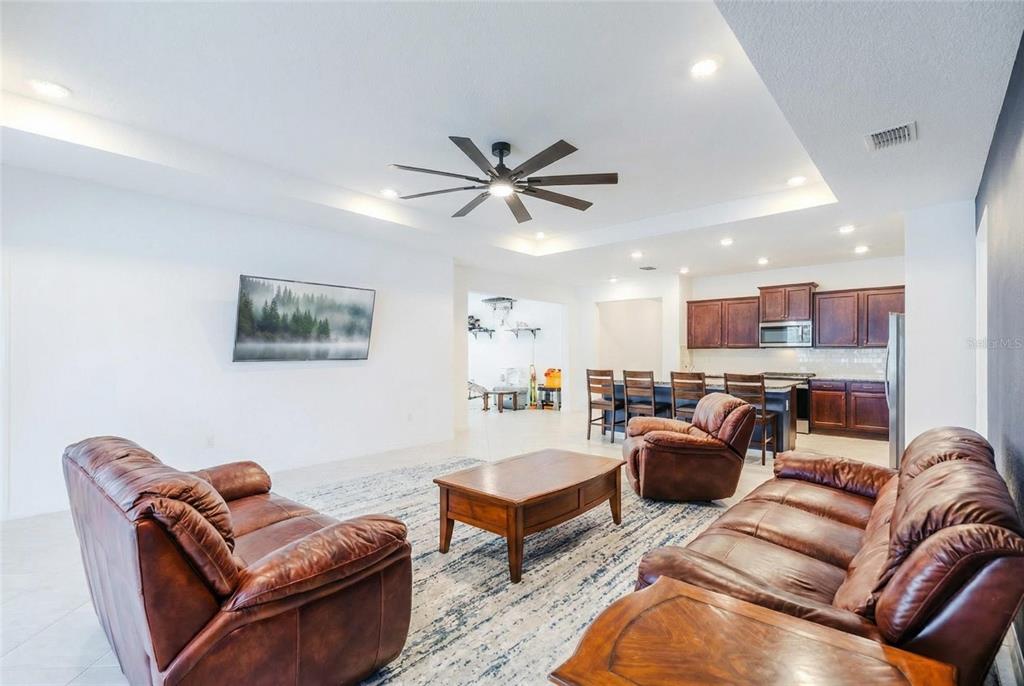 6200 Southwest 72nd Terrace Ocala, FL 34474 - Photo 29 of 70 a living room with furniture ceiling fan and a rug