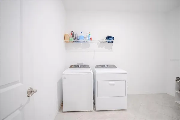 an empty room with a ceiling fan and window