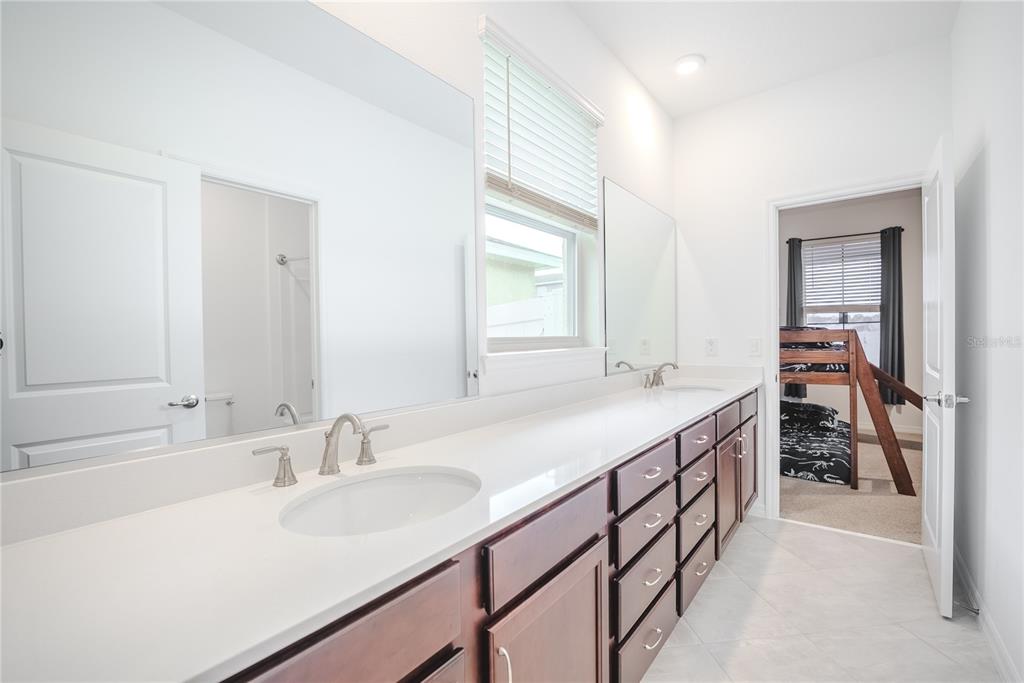 6200 Southwest 72nd Terrace Ocala, FL 34474 - Photo 49 of 70 a bathroom with a sink a vanity and a mirror