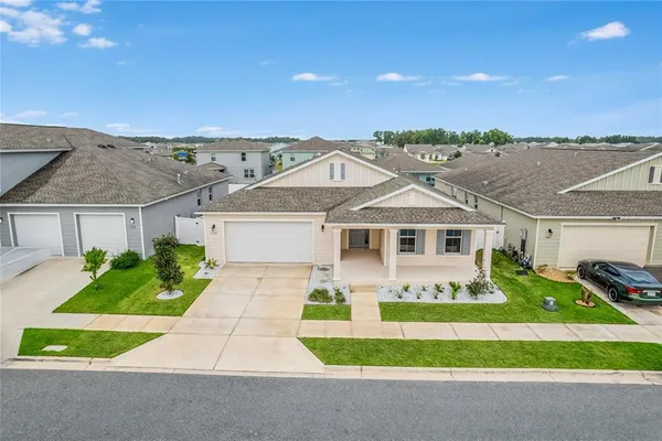 a front view of a house with a garden and yard