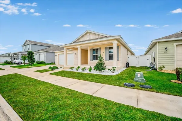 a front view of a house with a garden