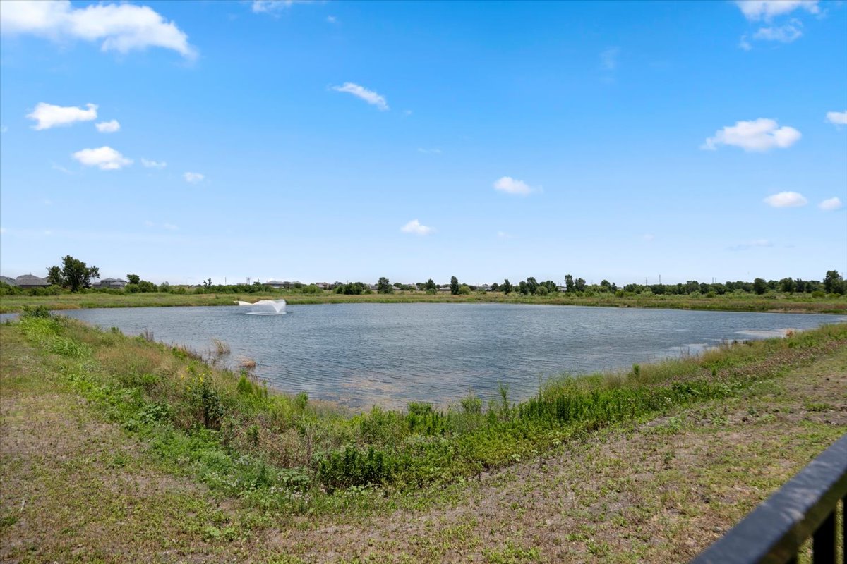 500 Stinchcomb Road Hutto, TX 78634 - Photo 6 of 37 Enjoy tranquil water views from this scenic property, featuring a serene pond with a graceful fountain.