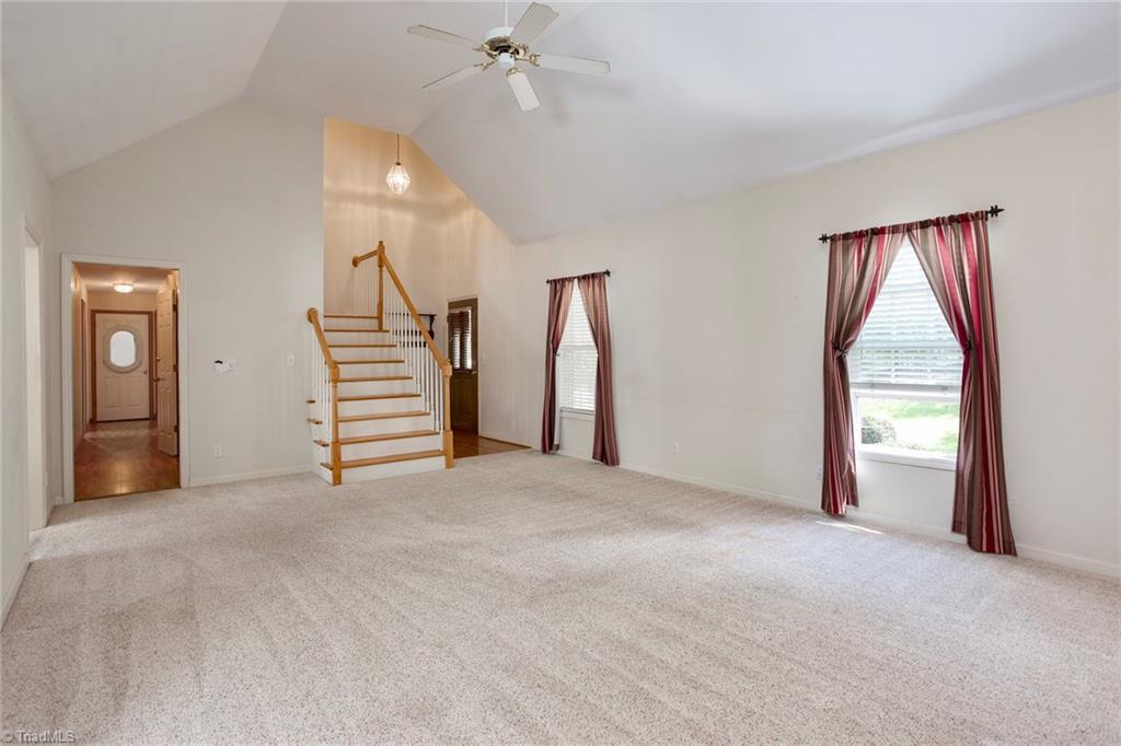 705 Old Mill Road High Point, NC 27265 - Photo 5 of 27 Oversized living room has cathedral ceiling and gas log fireplace.