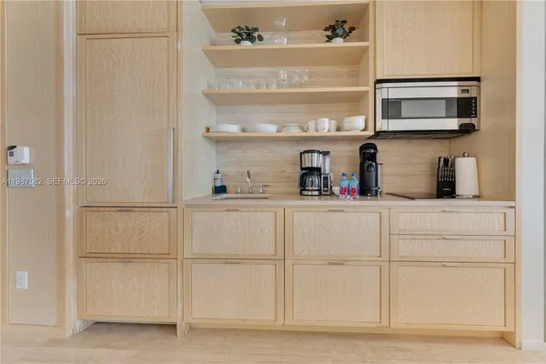 a kitchen with white cabinets and white appliances