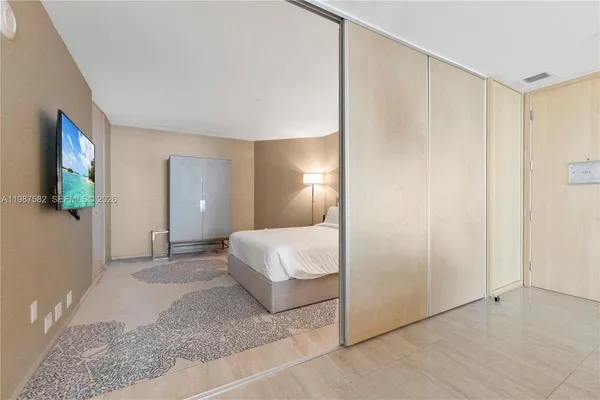 a spacious bedroom with a bed and a walk in closet