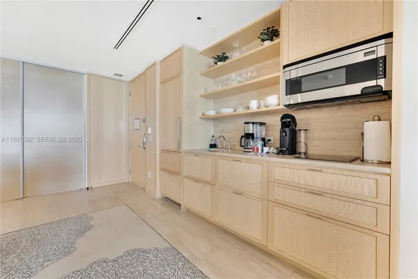a kitchen with cabinets and a refrigerator