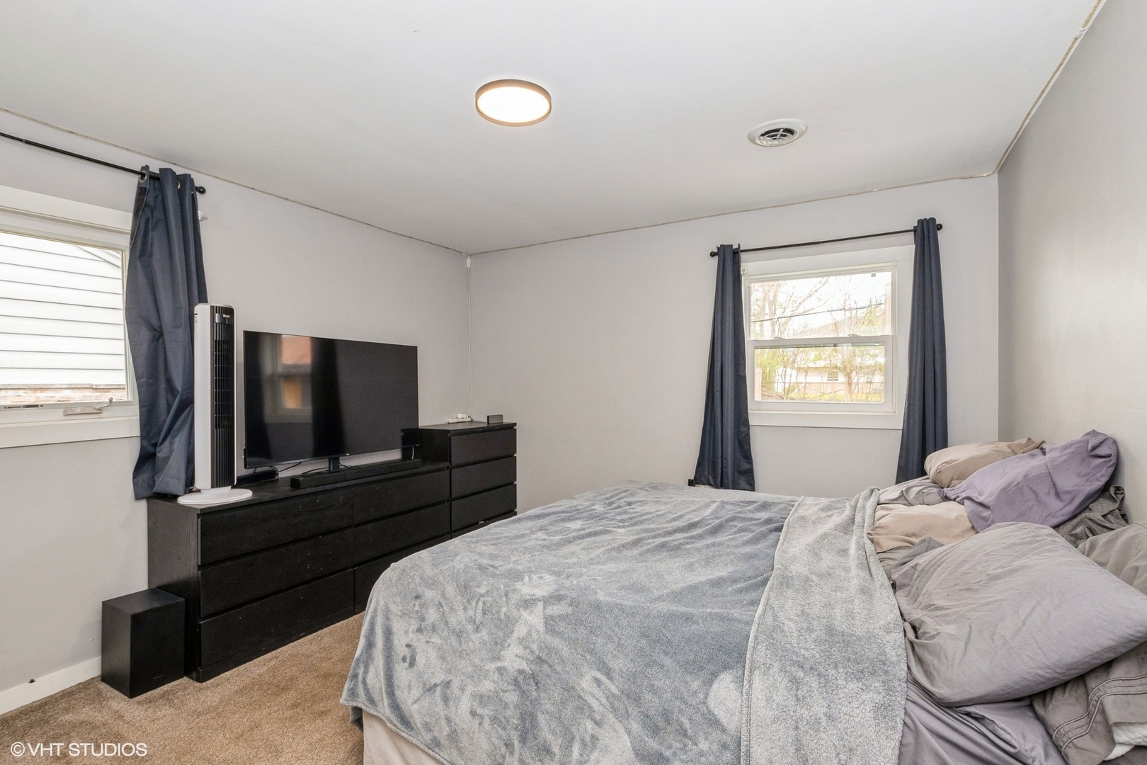 152 Monee Road Park Forest, IL 60466 - Photo 7 of 10 a bedroom with a bed and a flat screen tv