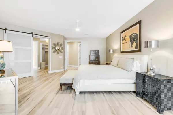 a spacious bedroom with a bed and a cabinets