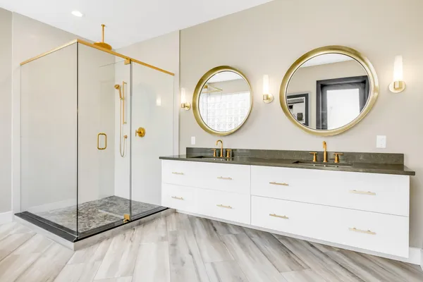 a bathroom with a double vanity sink mirror and a shower