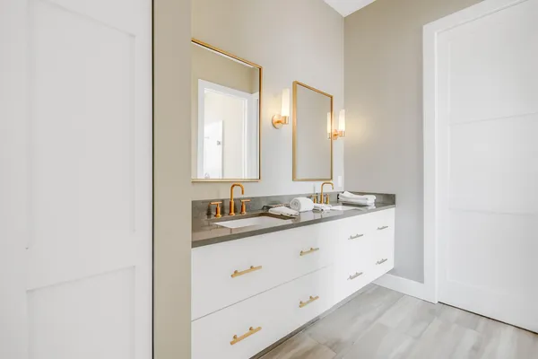 a bathroom with a double vanity sink and mirror