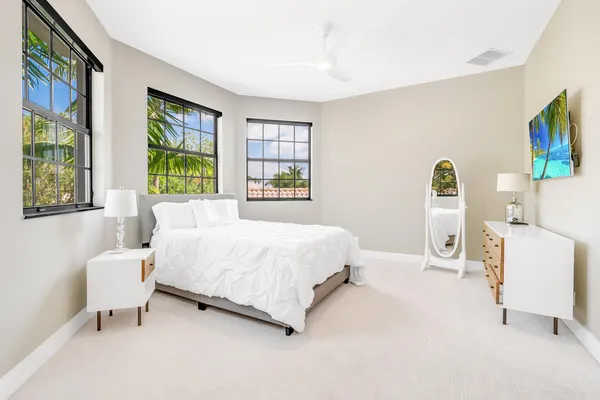 a bedroom with a bed chair and window