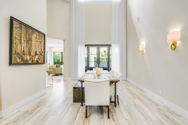 a dining room with furniture and wooden floor