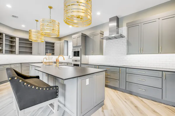 a kitchen with granite countertop a sink and cabinets