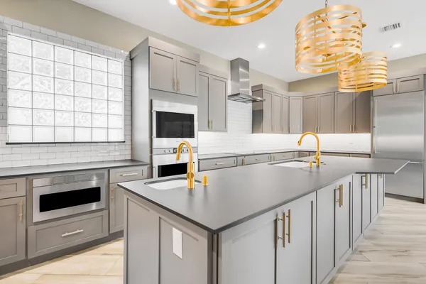 a kitchen with a sink a stove and cabinets