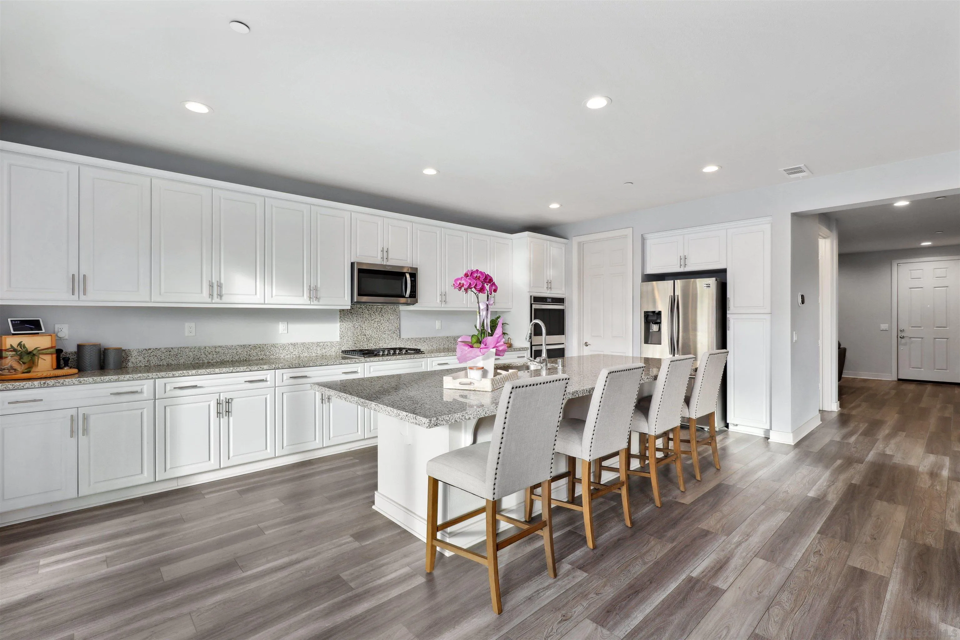 1294 Palomar Circle Escondido, CA 92027 - Photo 13 of 41 a kitchen with stainless steel appliances a dining table chairs microwave and sink