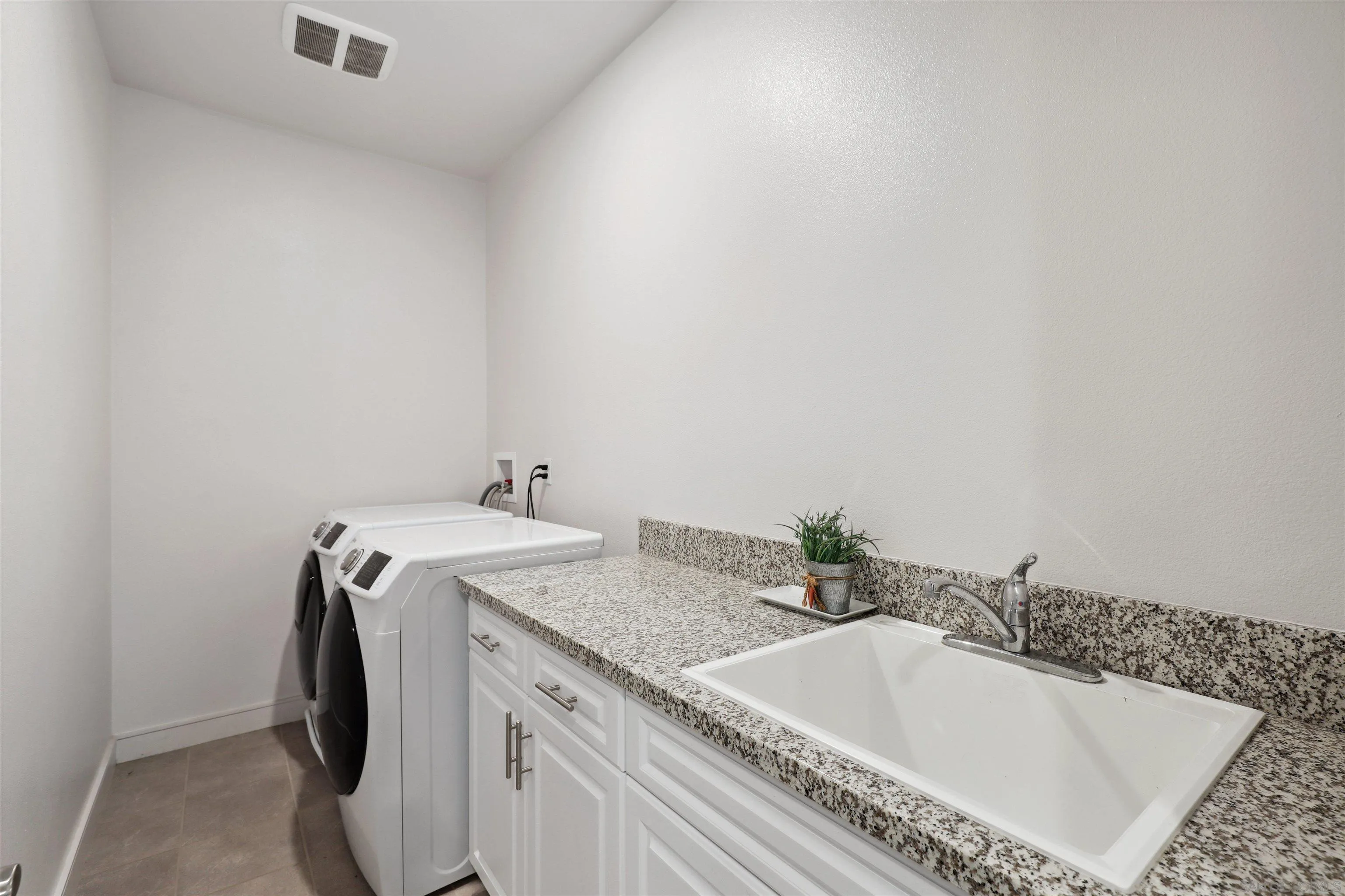 1294 Palomar Circle Escondido, CA 92027 - Photo 29 of 41 a bathroom with a granite countertop sink and a vanity